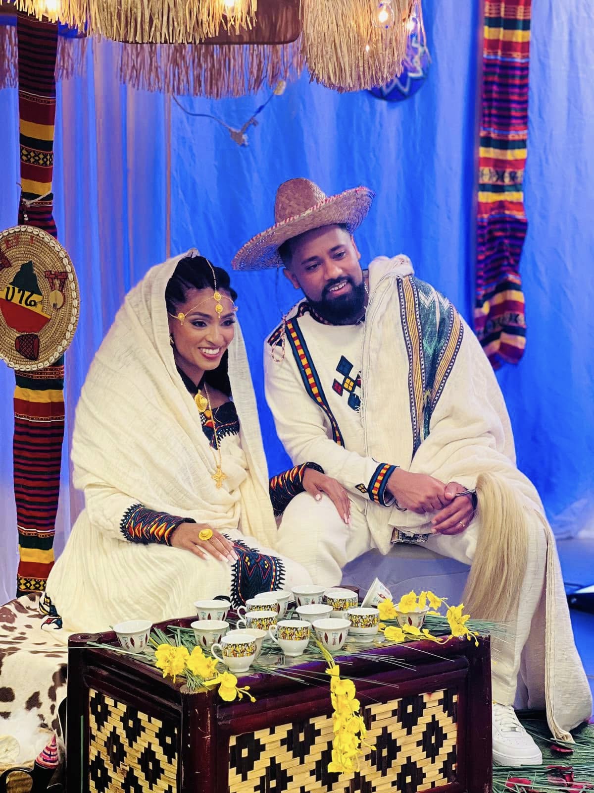 Couple in traditional habesha attire at a coffee ceremony